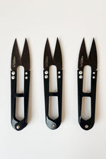 Load image into Gallery viewer, 3 thread snips aligned vertically. The handles are slightly shiny and black; the blades are dark grey. LDH logo on the left blade. 
