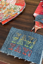 Load image into Gallery viewer, Triple YAY! embroidered patch on denim fabric. Part of heart shaped and squiggle shaped crumb quilted sew-on patches on the background.
