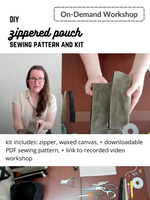 Load image into Gallery viewer, Woman holds zippered pouch to above camera. On-demand workshop. DIY zippered pouch sewing pattern and kit. Kit includes: zipper, waxed canvas, and downloadable PDF sewing pattern, and link to recorded video workshop. 

