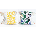 Load image into Gallery viewer, Two grain bags sit side by side showing front and back patchwork patterns. Front and back of patchwork (a mix of different floral prints) rectangle cherry pit grain bag. Sit on white background.
