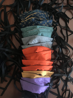 A row of fabric face masks with ties.