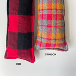 Load image into Gallery viewer, 2 cherry pit warmers in plaid from left to right with text: Red: large buffalo plaid in red and black. Crimson: small plaid in shades of red, orange, and grey. 
