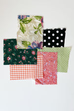 Load image into Gallery viewer, 6 small fabric swatches mainly in shades of pink, green, and black/white polka dot..
