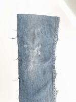 Load image into Gallery viewer, gif of sad cat head applique on denim leg swatch, switches to bare denim leg swatch. 
