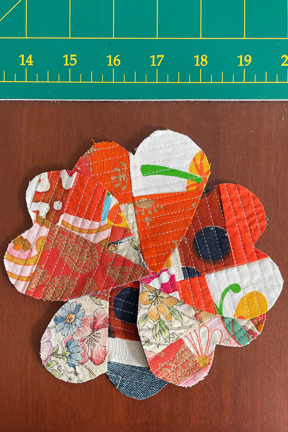 Heart shaped crumb quilt sew-on patches, spiraled out into a floral shape.