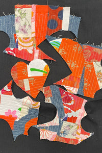 A heart shaped crumb quilt patch next to oddly shaped crumb quilt patches. 