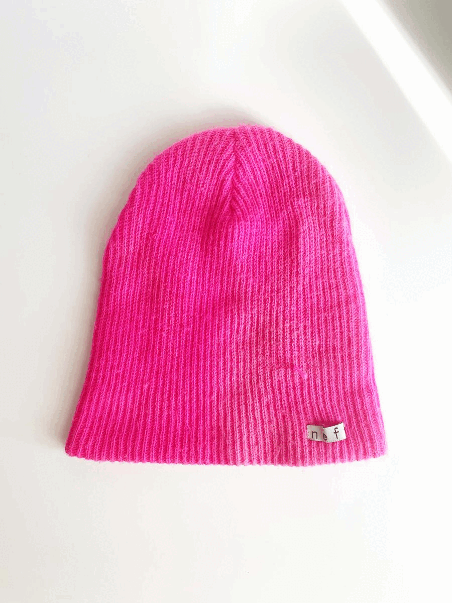 Gif: blank hot pink knit hat cuts to hat with rose bush applique on bottom right. 