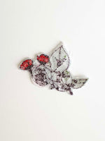 Load image into Gallery viewer, Back of embroidered rose bush shows clear adhesive backing with threads showing through. 
