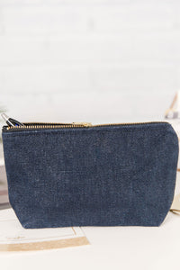 Navy blue zippered pouch with a pen coming out of it. 