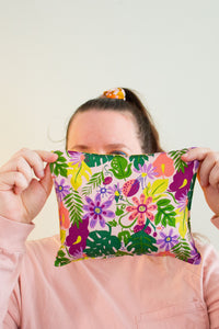 Woman holds a cherry pit grain bag covering most of her face.