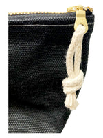 Load image into Gallery viewer, A close up of a black waxed canvas pouch with hemp zipper pull tied through the zipper pull. 
